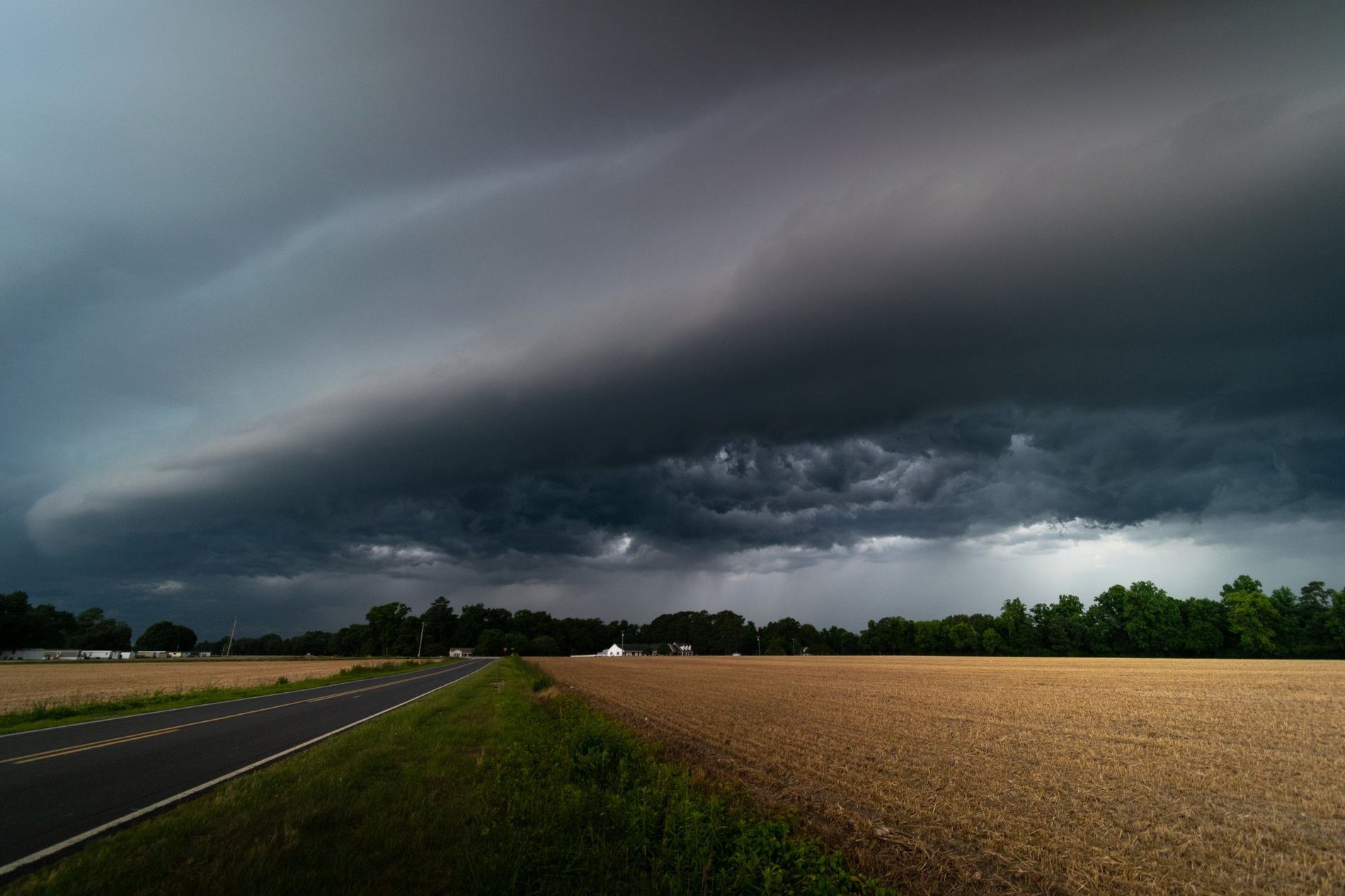 A shelf cloud moving across open farmland